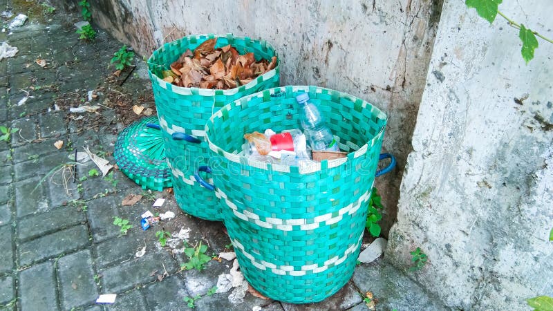 Two green trash bins made of woven plastic royalty free stock images