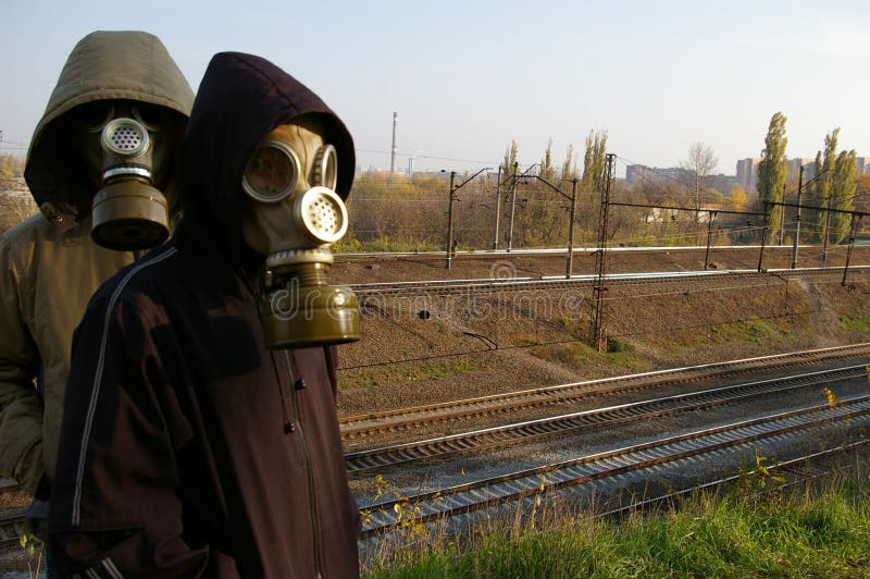 Two guys in masks, standing against a backdrop of stock images