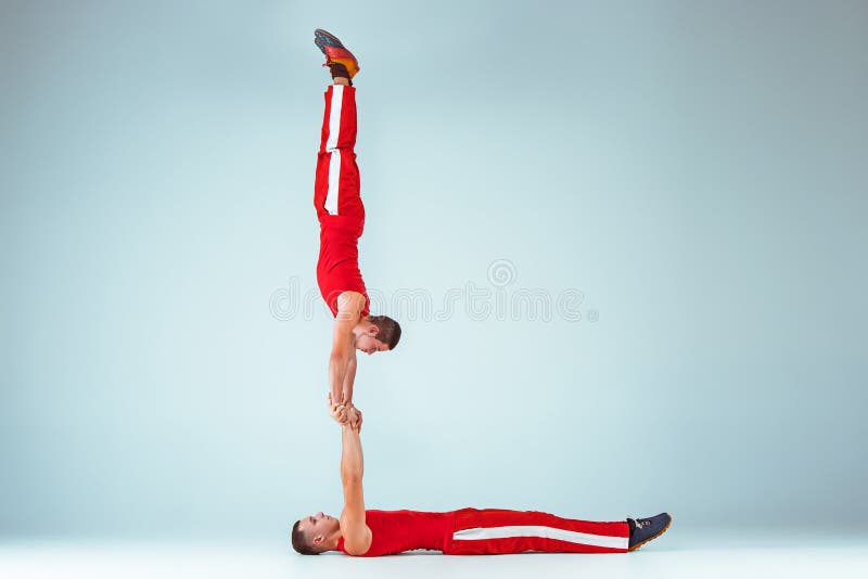 The Two Gymnastic Acrobatic Caucasian Men on Balance Pose Stock Image