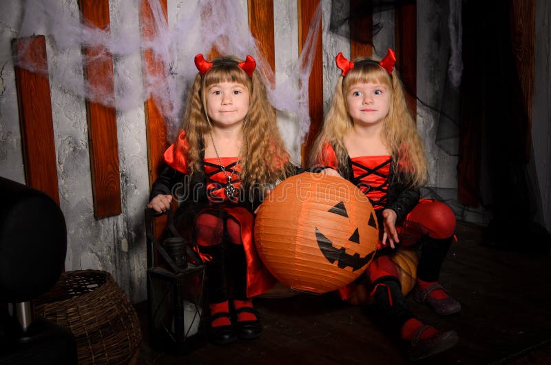 two halloween devils girls with pumpkins stock images two halloween devils girls with pumpkins stock images