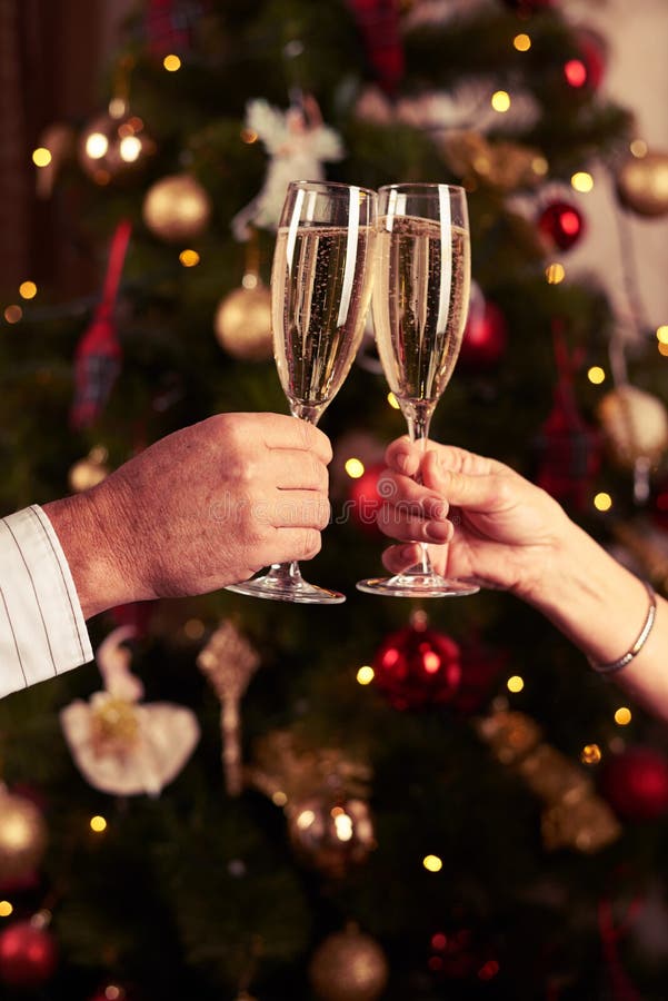 Two Hands Clinking Champagne Glasses Over Blurred New Year Background Stock Image Image Of