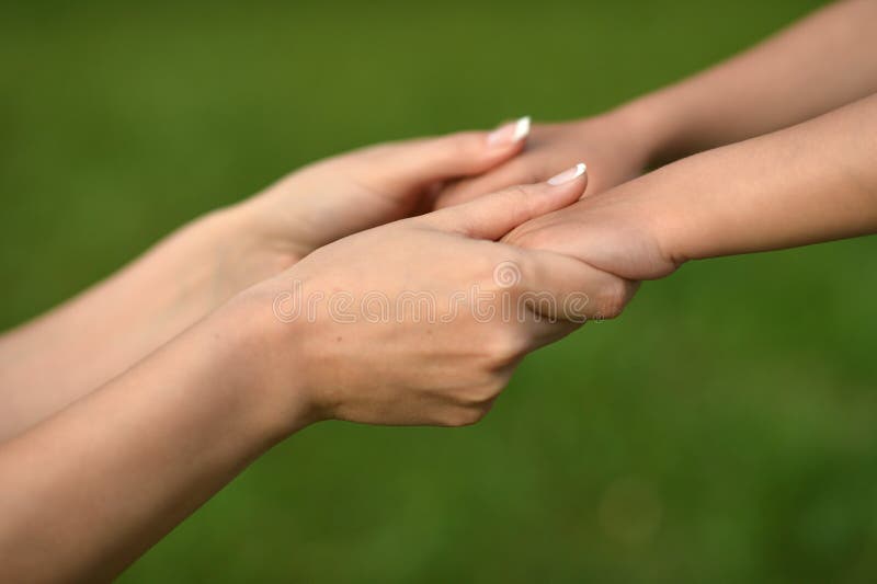 Two hands on green baackground,