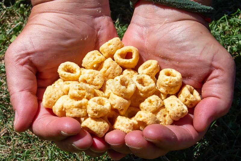 Two Hands Holding a Handful of Snacks. Salty Snacks. Fast Food Stock