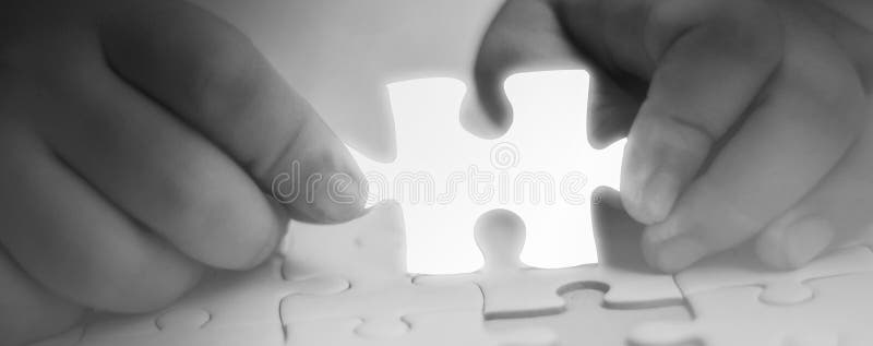 Two hands holding jigsaw puzzle piece glowing white glow piece missing components,Abstract concept business with success,goals and stock images Two hands holding jigsaw puzzle piece glowing white glow piece missing components,Abstract concept business with success,goals and stock images