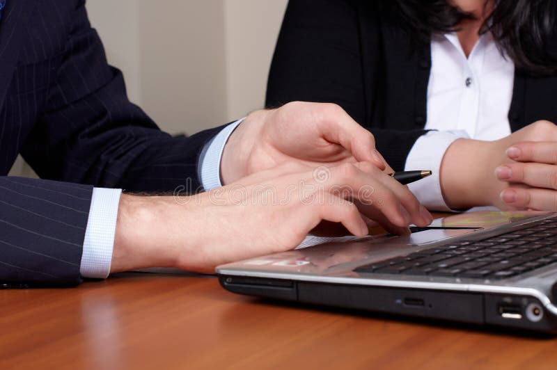 Two hands on keyboard of laptop