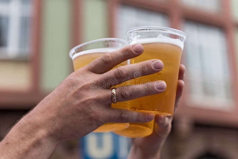 Two Hands and Three Full Plastic Cups with Beer Stock Image Image of