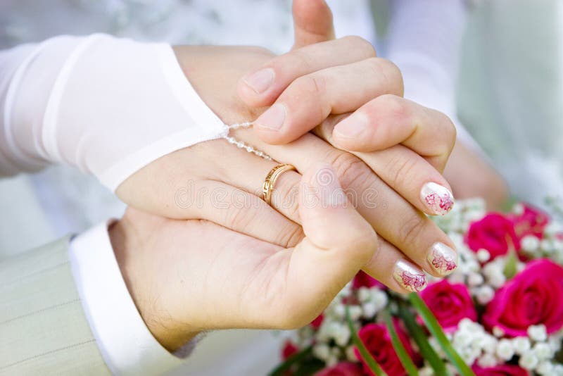 Two hands with a wedding ring