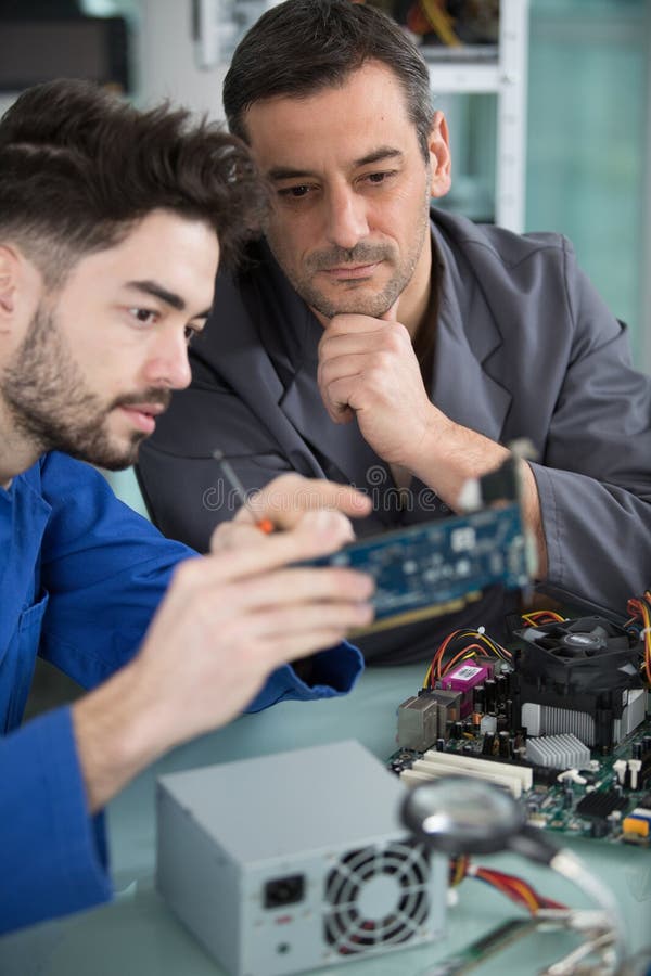 Two Handsome Engineers Working on Electronics Components Stock Photo