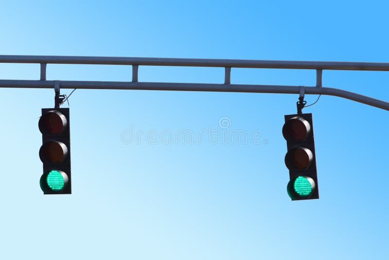 Two Hanging Traffic Signals with Green Lights royalty free stock photography