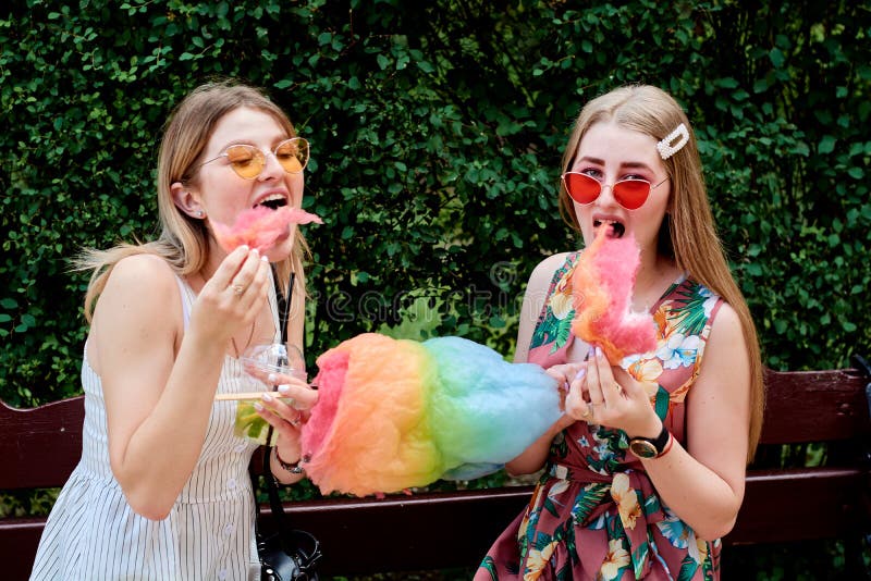 Two happy beautiful young sexy lesbian women with candy floss. Girlfriends day royalty free stock images Two happy beautiful young sexy lesbian women with candy floss. Girlfriends day royalty free stock images