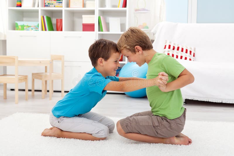 Two happy boys wrestling