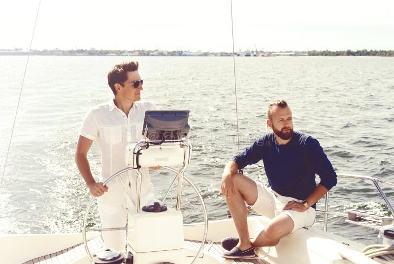 Two happy friends traveling on a yacht. Vacation, tourism, holid