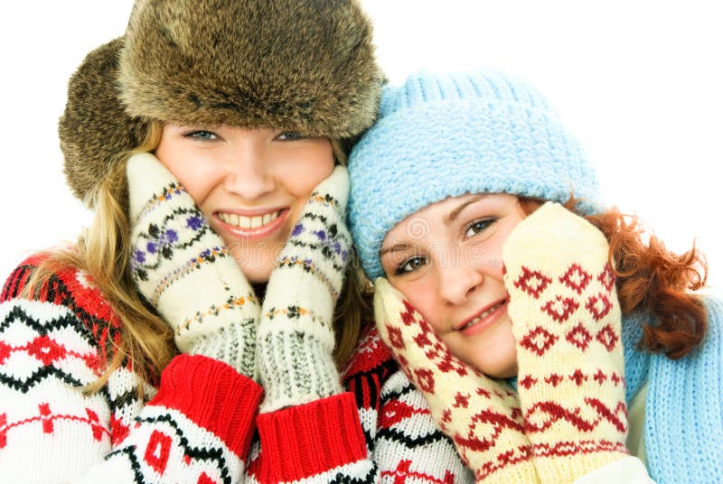 Two happy girls wearing warm winter clothes