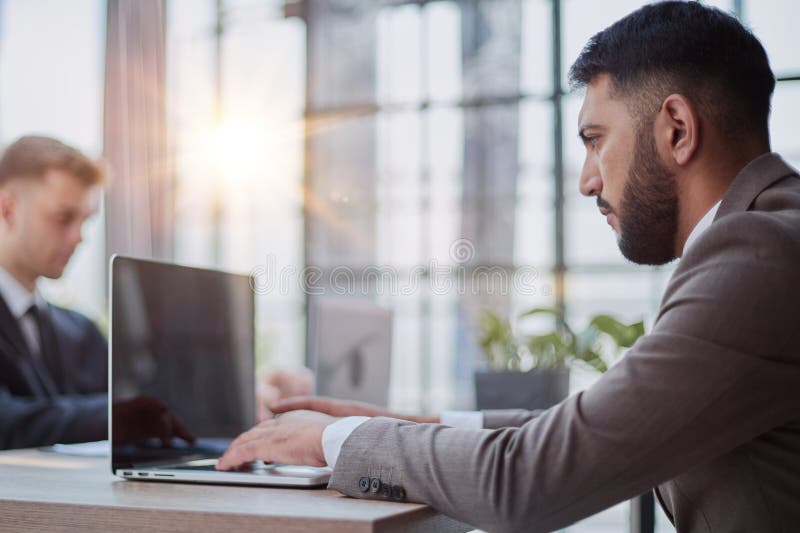 Two happy men working together on a new business project stock photography