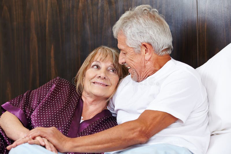 Two happy seniors in bed.