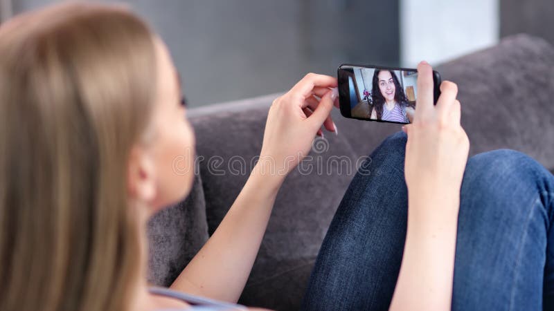 Two Happy Young Woman Enjoying Video Webcam Chatting Together Using Smartphone Close-up Stock Video - Video of informal, camera: 149762573