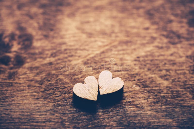 Two little light hearts on a wooden background. Love symbol. Valentine`s Day. Two little light hearts on a wooden background. Love symbol. Valentine`s Day.