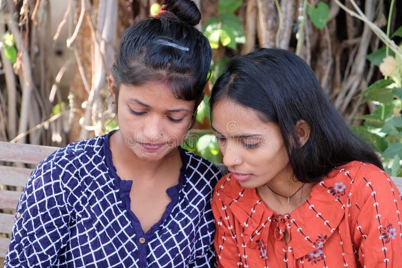 Indian Female Friends Talking To Each Other Sitting On A Bench Stock Image Image Of Pretty