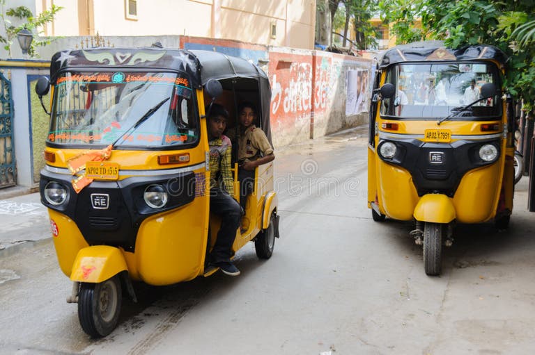 two-indian-moto-rickshaws-tuk-tuk-going-street-february-puttaparthi-india-two-indian-moto-rickshaws-tuk-tuk-going-117903658.jpg