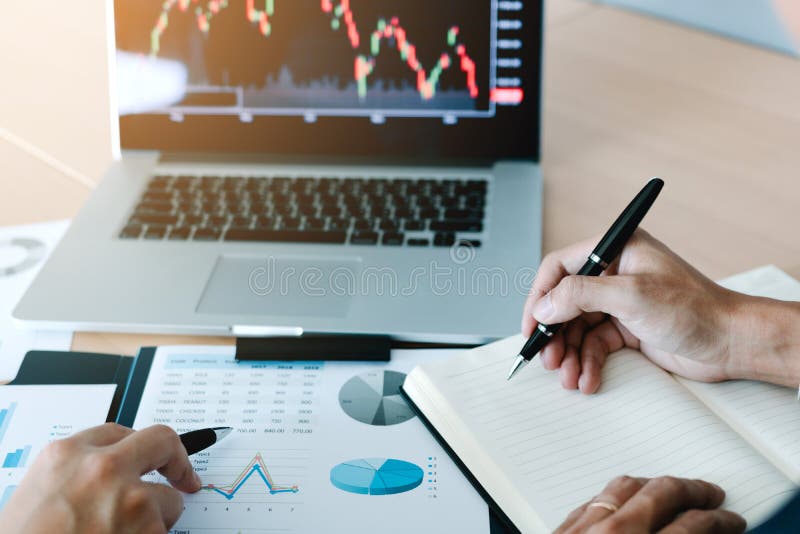 Two investors work together and note the stock price to compare with other stocks royalty free stock image Two investors work together and note the stock price to compare with other stocks royalty free stock image