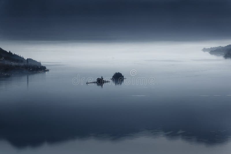 Two Islands near Perast in the Bay of Kotor in the early morning in the fog. 2019-02-17 08: 38 royalty free stock photo Two Islands near Perast in the Bay of Kotor in the early morning in the fog. 2019-02-17 08: 38 royalty free stock photo