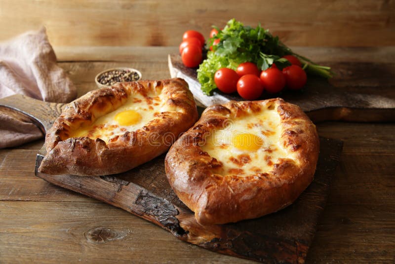 Khachapuri Adjara traditional Georgian dishes. Baked bread stuffed with cheese and eggs. stock photography Khachapuri Adjara traditional Georgian dishes. Baked bread stuffed with cheese and eggs. stock photography