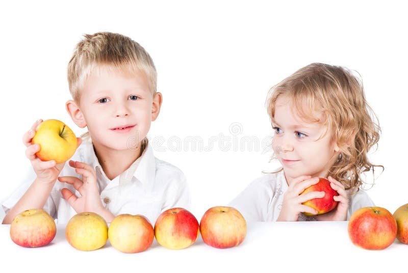 Two kids with apples isolated on white