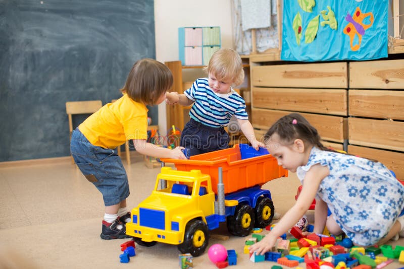 Two kids conflict for toy truck in kindergarten