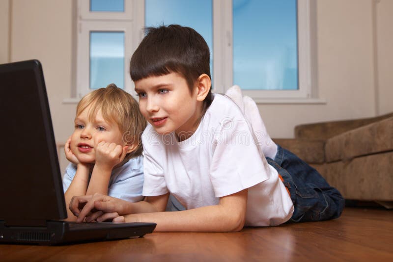 Two kids playing computer game