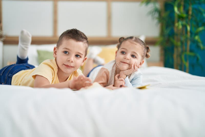 Two Kids Reading Story Book Lying on Bed at Bedroom Stock Image Image