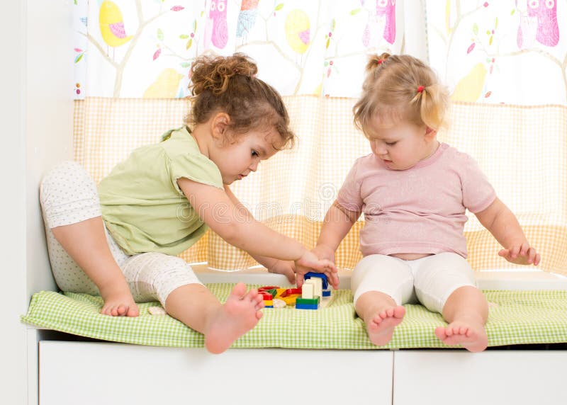 Two kids sisters play together