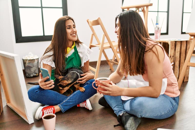 Two Latin Paint Students Drinking Coffee and Using Smartphone with Dog