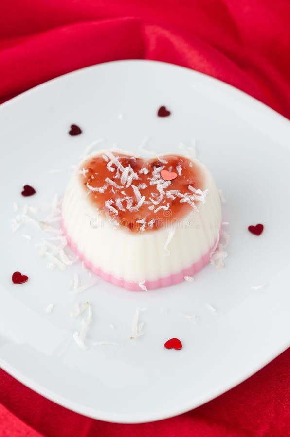 Two-layer dessert with coconut cream in the form of heart on a r