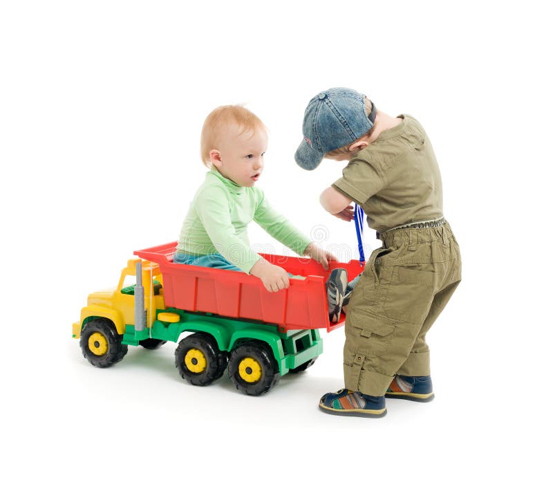 Two little boys play with toy truck