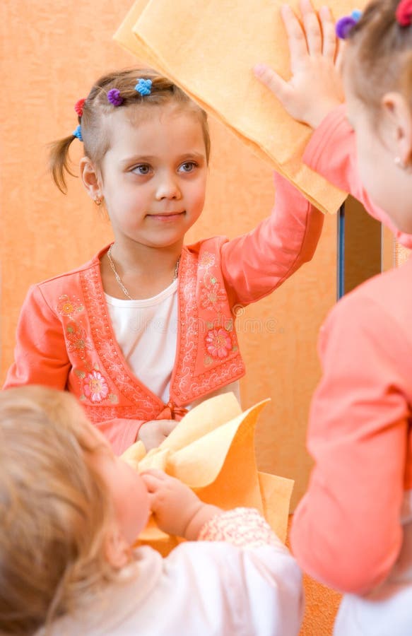 Two little girl cleaning mirror