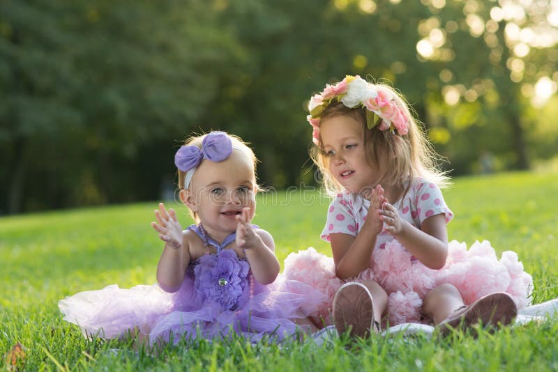 Two little girl a little girl sitting