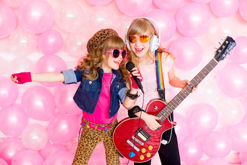 Two little girl with a microphone stock photos Two little girl with a microphone stock photos