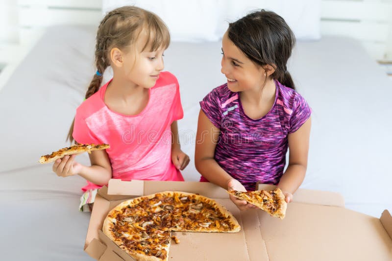 Two Little Girls Eating Huge Pizza at Home Stock Photo Image of party