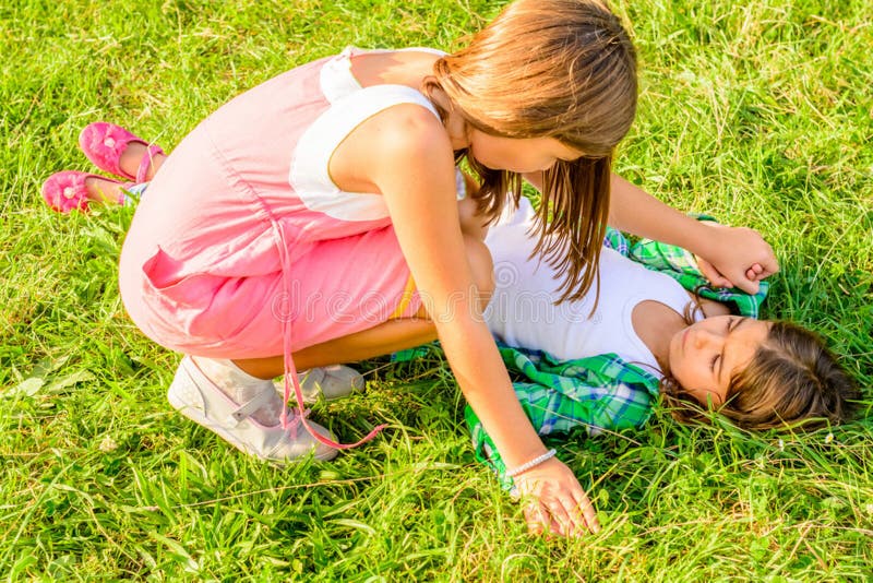 Two little girls fighting stock image. Image of grass 46949217