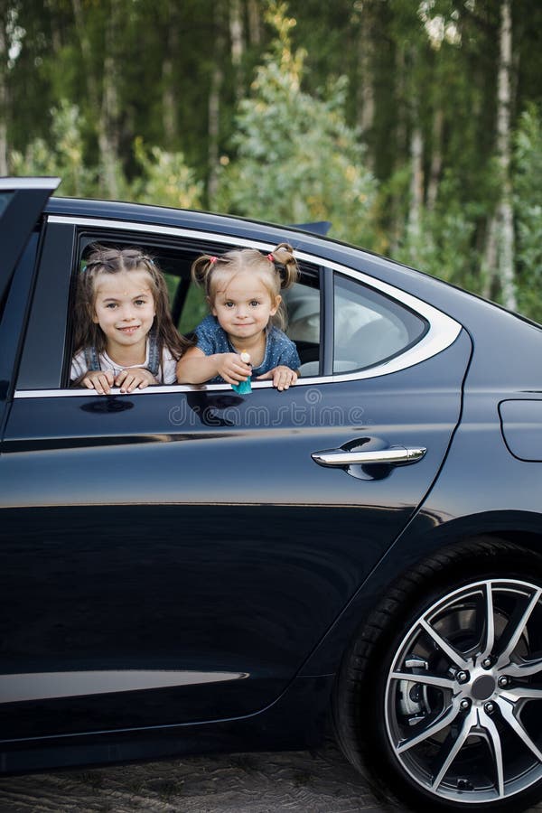 Two Little Girls Look Through A Car Window Stock Image Image of girls