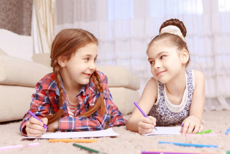 Two Little Girls Lying On Carpet Stock Photo Image Of Pencil Learn