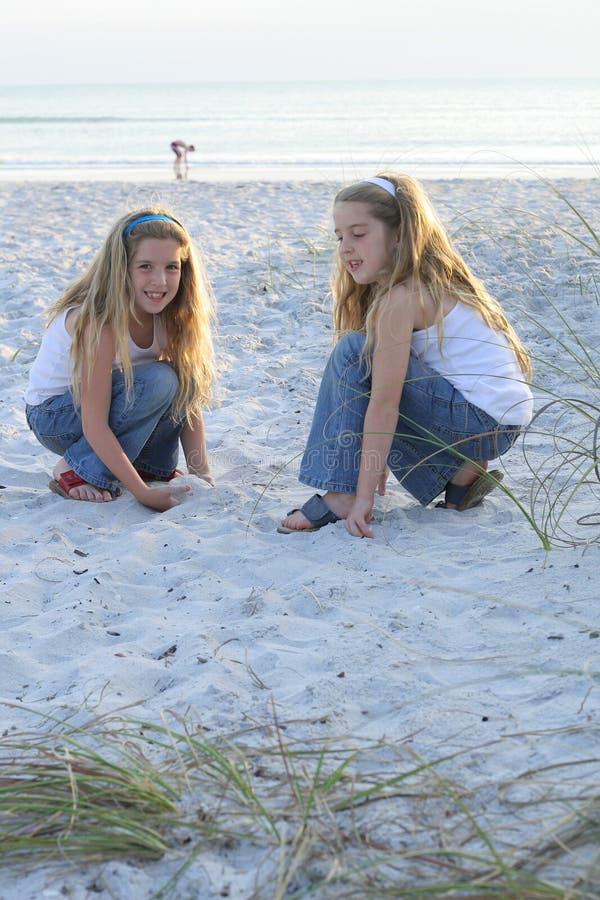 Two little girls playing in the sand