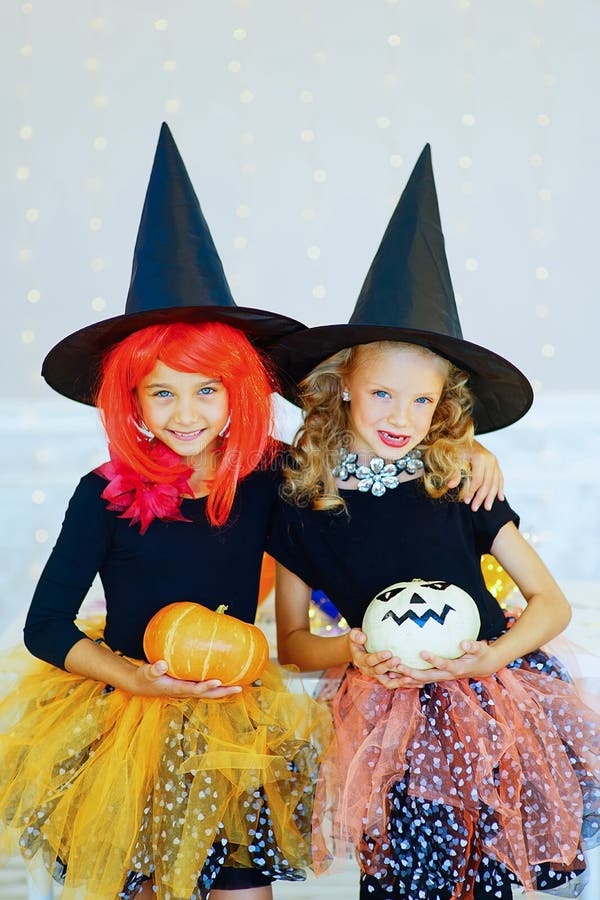 Two Little Girls in Witch Costume Playing with Pumpkins Stock Photo ...