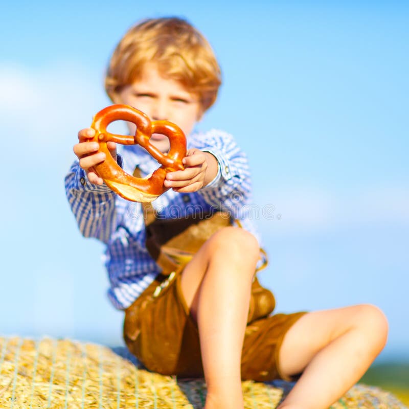 Two little kid boys and friends sitting on hay stack