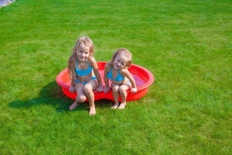 Two Little Sisters Frolicing And Splashing In Stock Image Image Of