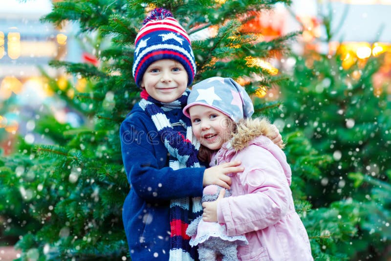 Two Little Smiling Kids, Boy and Girl with Christmas Tree Stock Photo ...