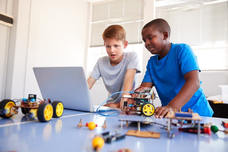 Two Male Students Building And Programing Robot Vehicle In After School Computer Coding Class stock photos