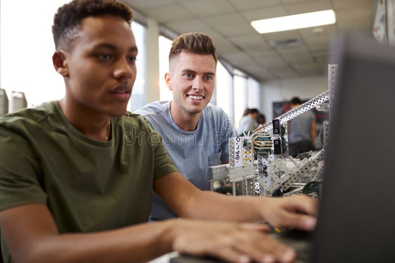Two Male University Students Building Machine In Science Robotics Or Engineering Class stock photos