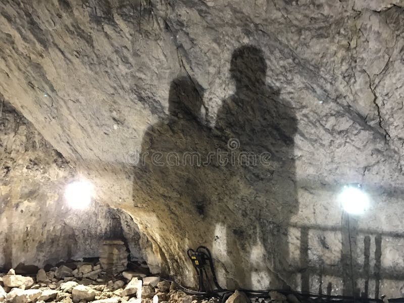 Two mans shadows on a wall in alomita Cave, located in the Valley lalomitei, Gorge Cave, at an altitude of 1660 m, Romania. Two mans shadows on a wall in alomita Cave, located in the Valley lalomitei, Gorge Cave, at an altitude of 1660 m, Romania