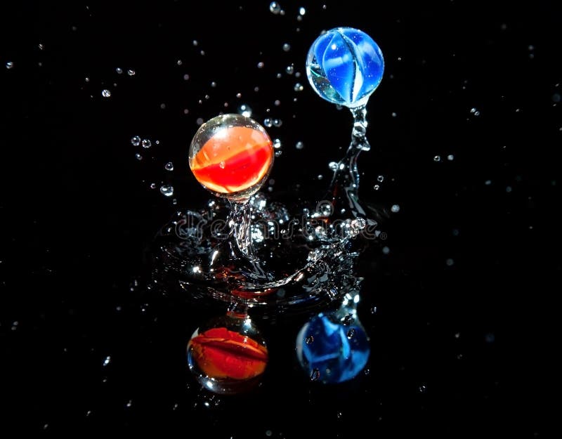 Two marbles bouncing on wet surface stock photos Two marbles bouncing on wet surface stock photos